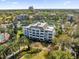 Aerial view of a multi-story condo with surrounding green space and nearby community at 7613 Cabana Ct # 402, Reunion, FL 34747