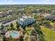 Stunning aerial view of a resort with a pool, lush landscaping, and well-maintained buildings on a sunny day at 7613 Cabana Ct # 402, Reunion, FL 34747