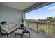 Relaxing balcony with comfortable seating, plants, and a scenic view of lush greenery and palm trees at 7613 Cabana Ct # 402, Reunion, FL 34747