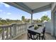 Spacious balcony with elegant railing, a dining table with chairs, and a view of palm trees at 7613 Cabana Ct # 402, Reunion, FL 34747