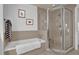 This well-lit bathroom includes a standalone tub, and glass enclosed shower at 7613 Cabana Ct # 402, Reunion, FL 34747