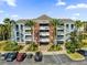 Beautiful condo building with tropical landscaping and ample parking at 7613 Cabana Ct # 402, Reunion, FL 34747