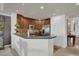 Open kitchen with stainless steel appliances, granite countertops, and stylish wood cabinets at 7613 Cabana Ct # 402, Reunion, FL 34747