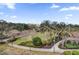 Picturesque landscaped view with winding paths, mature trees, colorful shrubbery, and decorative lighting fixtures at 7613 Cabana Ct # 402, Reunion, FL 34747