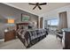 This bedroom includes carpeted floors, ceiling fan, nightstands, and a large window at 7613 Cabana Ct # 402, Reunion, FL 34747