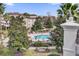 Inviting pool area featuring lounge chairs, umbrellas, tropical trees, and well-maintained landscaping at 7613 Cabana Ct # 402, Reunion, FL 34747
