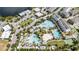 Aerial view of community amenities including pools, sports courts, parking, and lush landscaping at 7845 Dausset St, Orlando, FL 32827