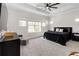 Serene bedroom with a modern ceiling fan, tray ceiling, and neutral color palette at 7845 Dausset St, Orlando, FL 32827