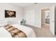 Cozy bedroom with neutral walls, carpeted floors, and ensuite bathroom offers comfort and convenience at 7845 Dausset St, Orlando, FL 32827
