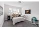 Bright bedroom featuring three windows, carpeted floors, and neutral walls, providing ample natural light and comfort at 7845 Dausset St, Orlando, FL 32827