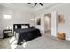 Spacious bedroom with tray ceilings and an open doorway to a luxurious bathroom at 7845 Dausset St, Orlando, FL 32827