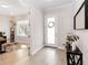 Bright foyer featuring hardwood floors, an adjacent office, and a welcoming front door with a wreath at 7845 Dausset St, Orlando, FL 32827