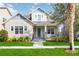Charming two-story home featuring a landscaped front yard and welcoming front porch with swing at 7845 Dausset St, Orlando, FL 32827