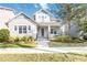 Charming two-story home featuring a landscaped front yard and welcoming front porch with swing at 7845 Dausset St, Orlando, FL 32827
