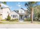 Charming two-story home featuring a landscaped front yard and inviting front porch with stone accents at 7845 Dausset St, Orlando, FL 32827