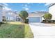 Charming one-story home with a manicured lawn, mature trees, and a two-car garage in a Gathering-friendly neighborhood at 7845 Dausset St, Orlando, FL 32827