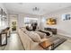 Bright living room features a large sectional sofa, hardwood floors and large windows at 7845 Dausset St, Orlando, FL 32827
