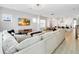 Spacious living room with hardwood floors connects to kitchen and dining area; large sectional sofa at 7845 Dausset St, Orlando, FL 32827