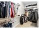 Well-organized walk-in closet with ample hanging space and shelving for clothes and accessories at 7845 Dausset St, Orlando, FL 32827