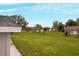 Large backyard with well-maintained lawn and mature trees providing shade and privacy at 820 E Flag Ln, Kissimmee, FL 34759