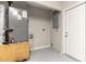 Unfinished basement featuring utility equipment and a door to another area at 820 E Flag Ln, Kissimmee, FL 34759