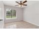 This bedroom features a large window with backyard views and tiled flooring at 820 E Flag Ln, Kissimmee, FL 34759