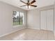 Bedroom featuring a ceiling fan, closet and a window that brings in natural light at 820 E Flag Ln, Kissimmee, FL 34759