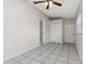 This bedroom features tile flooring, a ceiling fan, and access to other areas of the home at 820 E Flag Ln, Kissimmee, FL 34759