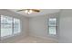 Bedroom with tile flooring, two windows and a ceiling fan at 820 E Flag Ln, Kissimmee, FL 34759