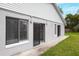 View of the back exterior of the home with slider door and large window at 820 E Flag Ln, Kissimmee, FL 34759