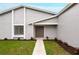 Close up of gray home's double front doors with new landscaping at 820 E Flag Ln, Kissimmee, FL 34759