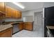 Bright kitchen features wooden cabinets, granite countertops and stainless steel appliances at 820 E Flag Ln, Kissimmee, FL 34759