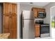 Kitchen features stainless steel appliances and wooden cabinets with granite countertops at 820 E Flag Ln, Kissimmee, FL 34759