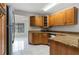 Kitchen with wood cabinetry, stainless steel appliances, and granite countertops at 820 E Flag Ln, Kissimmee, FL 34759