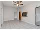 Spacious living room boasts a ceiling fan and sliding glass doors to the exterior at 820 E Flag Ln, Kissimmee, FL 34759