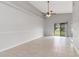 Open living room with tile floors, high ceilings and a sliding glass door at 820 E Flag Ln, Kissimmee, FL 34759