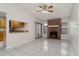 Bright living room with brick fireplace, fan, and view to the kitchen at 820 E Flag Ln, Kissimmee, FL 34759