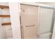 Shower with glass doors, a grab bar, and floating shelves in renovated bathroom at 820 Rayston, Deltona, FL 32725