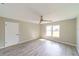 Bright bedroom features wood-look flooring, neutral walls, ceiling fan, and a large window at 820 Rayston, Deltona, FL 32725