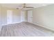 Spacious bedroom with gray wood-look floors, white trim, three closets, and neutral paint at 820 Rayston, Deltona, FL 32725