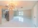 Modern dining area with statement lighting fixture adjacent to stainless steel kitchen appliances at 820 Rayston, Deltona, FL 32725