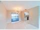 Bright dining space with sliding glass doors to pool area and a modern light fixture at 820 Rayston, Deltona, FL 32725