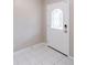 Bright foyer with geometric-patterned door and tiled floor at 820 Rayston, Deltona, FL 32725