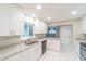 Bright kitchen features white cabinets, stainless steel appliances, and granite countertops at 820 Rayston, Deltona, FL 32725