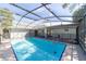 The crystal-clear pool with a screen enclosure offers a refreshing escape and enhances outdoor living at 820 Rayston, Deltona, FL 32725