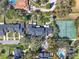 Overhead view of townhomes with tennis courts, mature trees, and manicured green spaces at 8314 Tangelo Tree Dr, Orlando, FL 32836