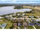 Expansive aerial view showcases a lakeside community with well-manicured lawns and beautiful homes at 9518 Lynwood St, Clermont, FL 34711