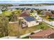 Aerial view of a home with a patio, fenced yard, and proximity to a lake at 9518 Lynwood St, Clermont, FL 34711