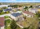 The aerial view highlights a home with a patio, fence, and well-maintained lawn at 9518 Lynwood St, Clermont, FL 34711