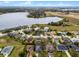 Expansive aerial view showcases a lakeside community with well-manicured lawns and beautiful homes at 9518 Lynwood St, Clermont, FL 34711